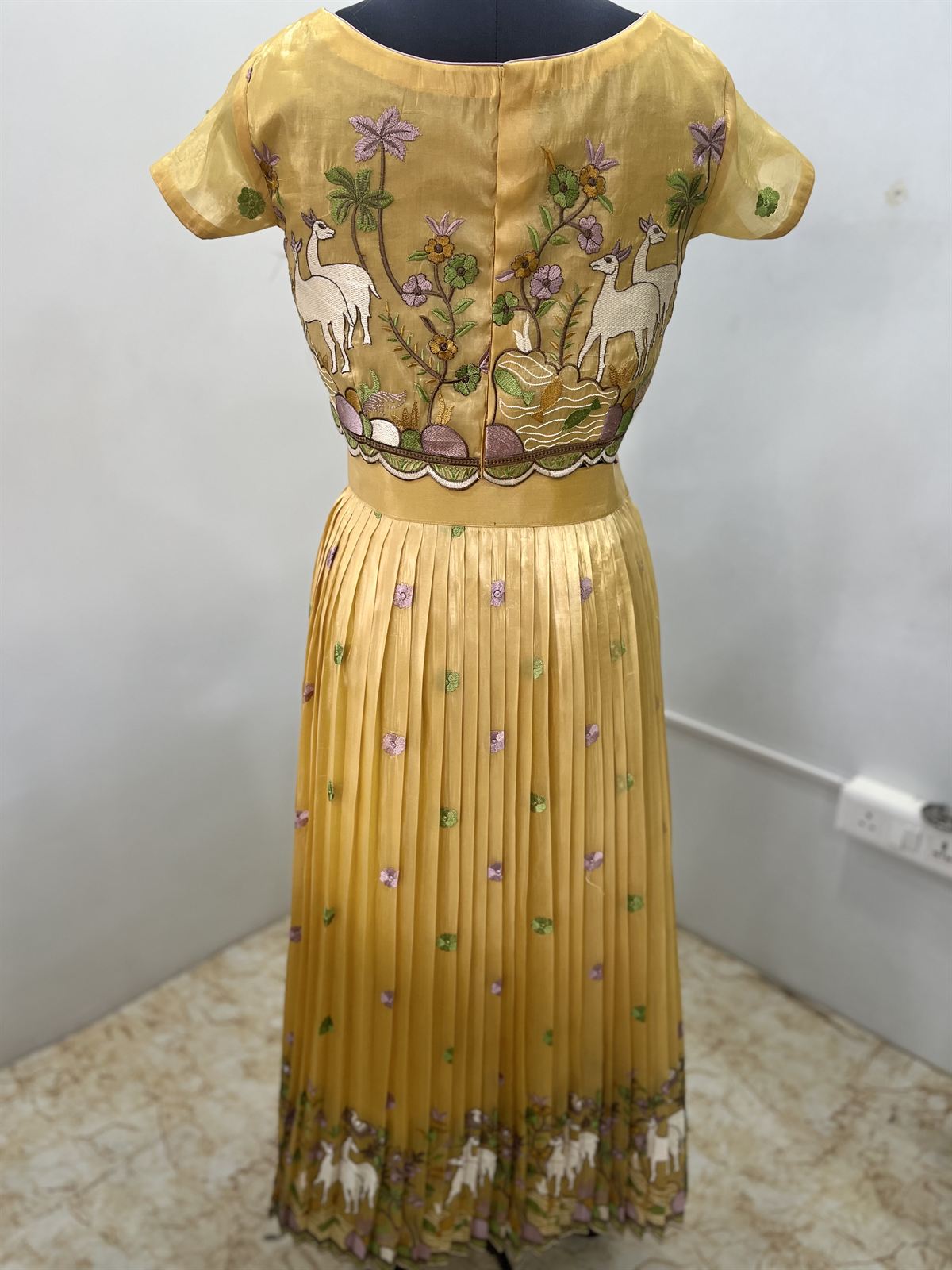 Mustard crop top and pleated skirt with pichwai-style cow and lotus motifs